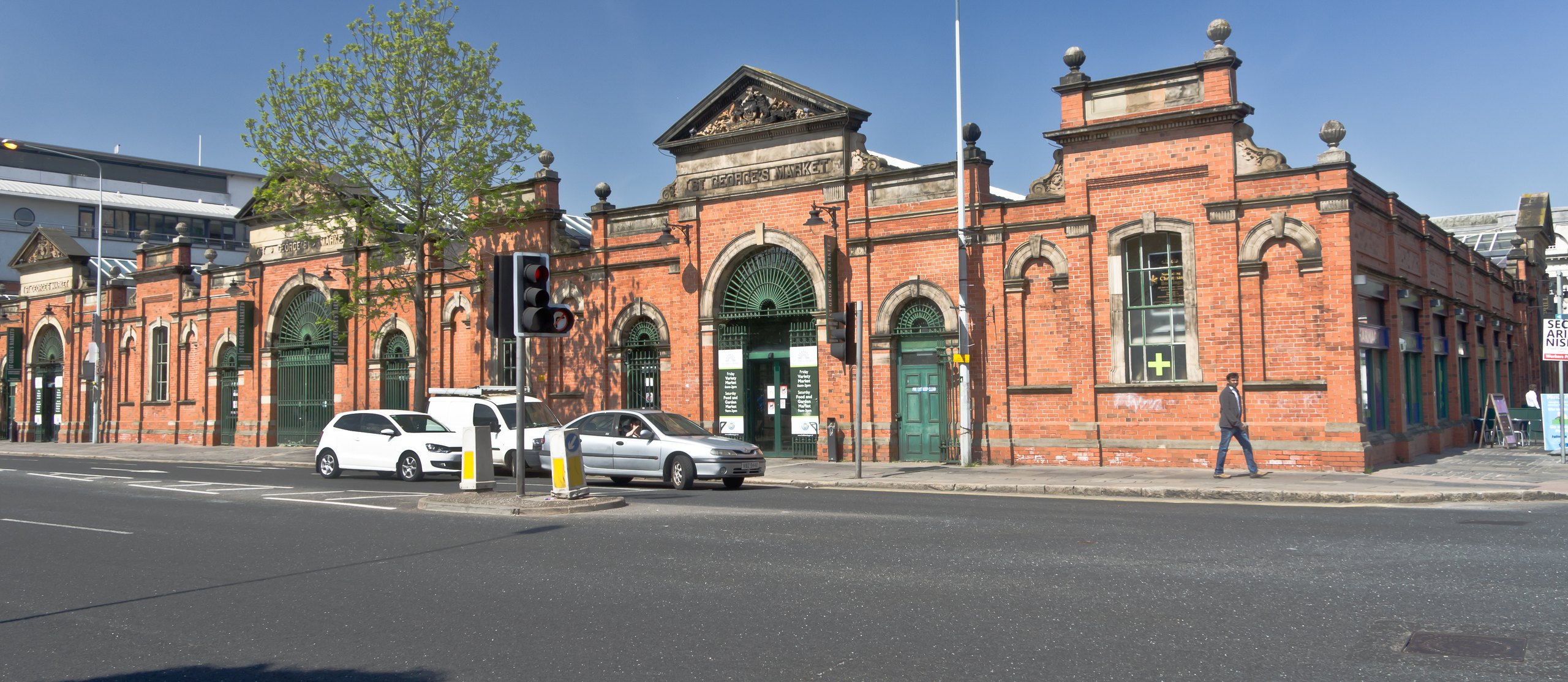 The red-brick St George's Market in Belfast under a blue sky