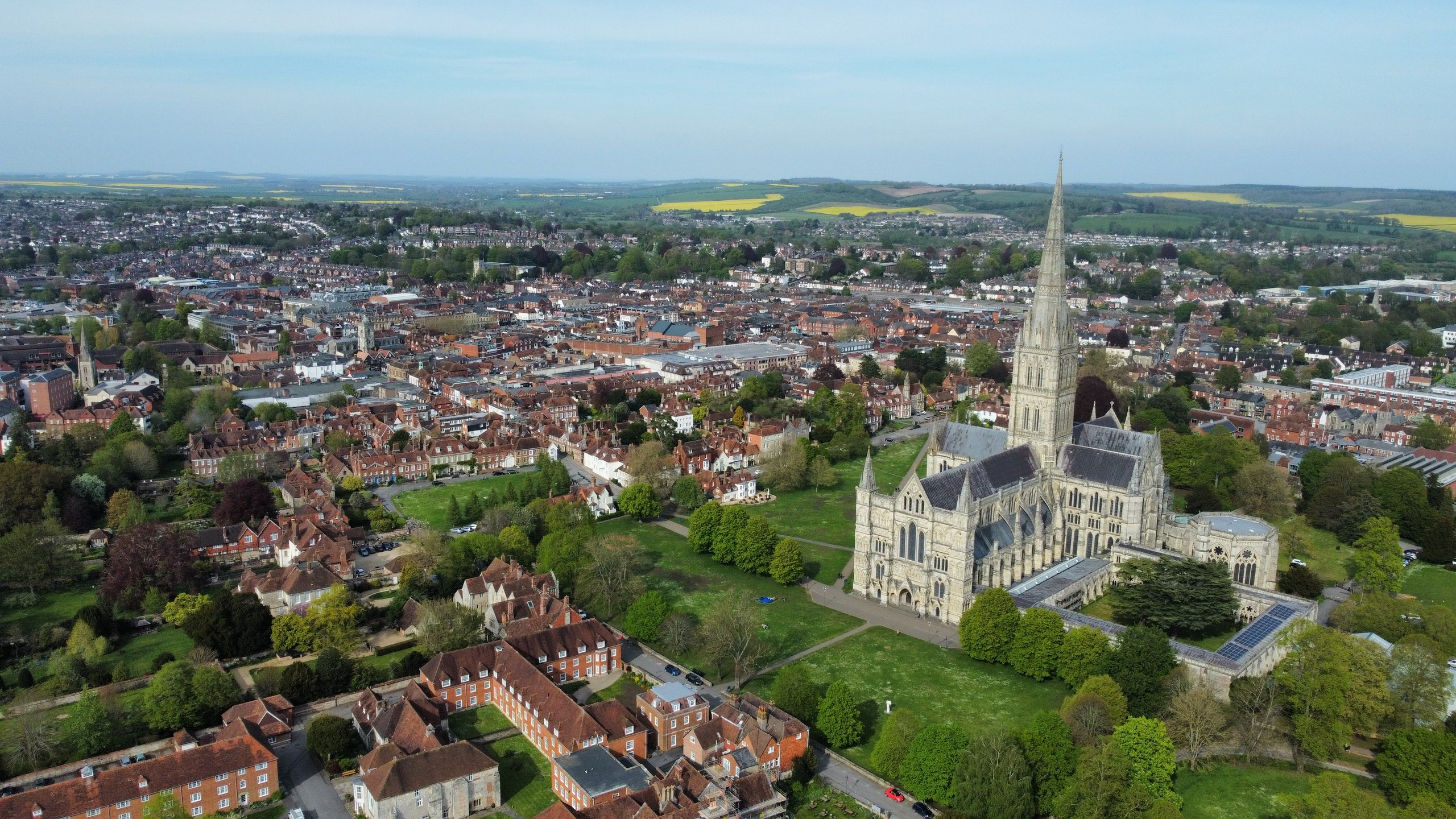 Salisbury Cathedral spire rising above the city in an aerial view