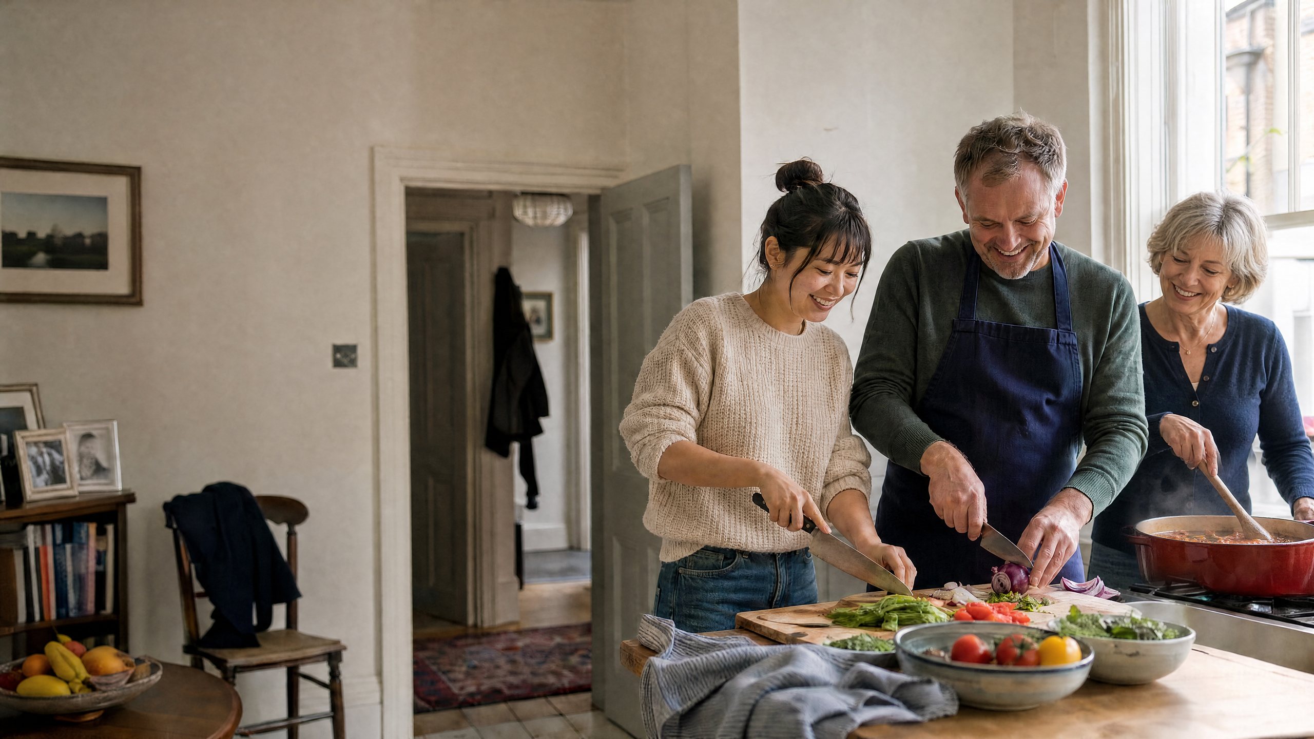 A host couple and an international student cooking dinner together in the kitchen